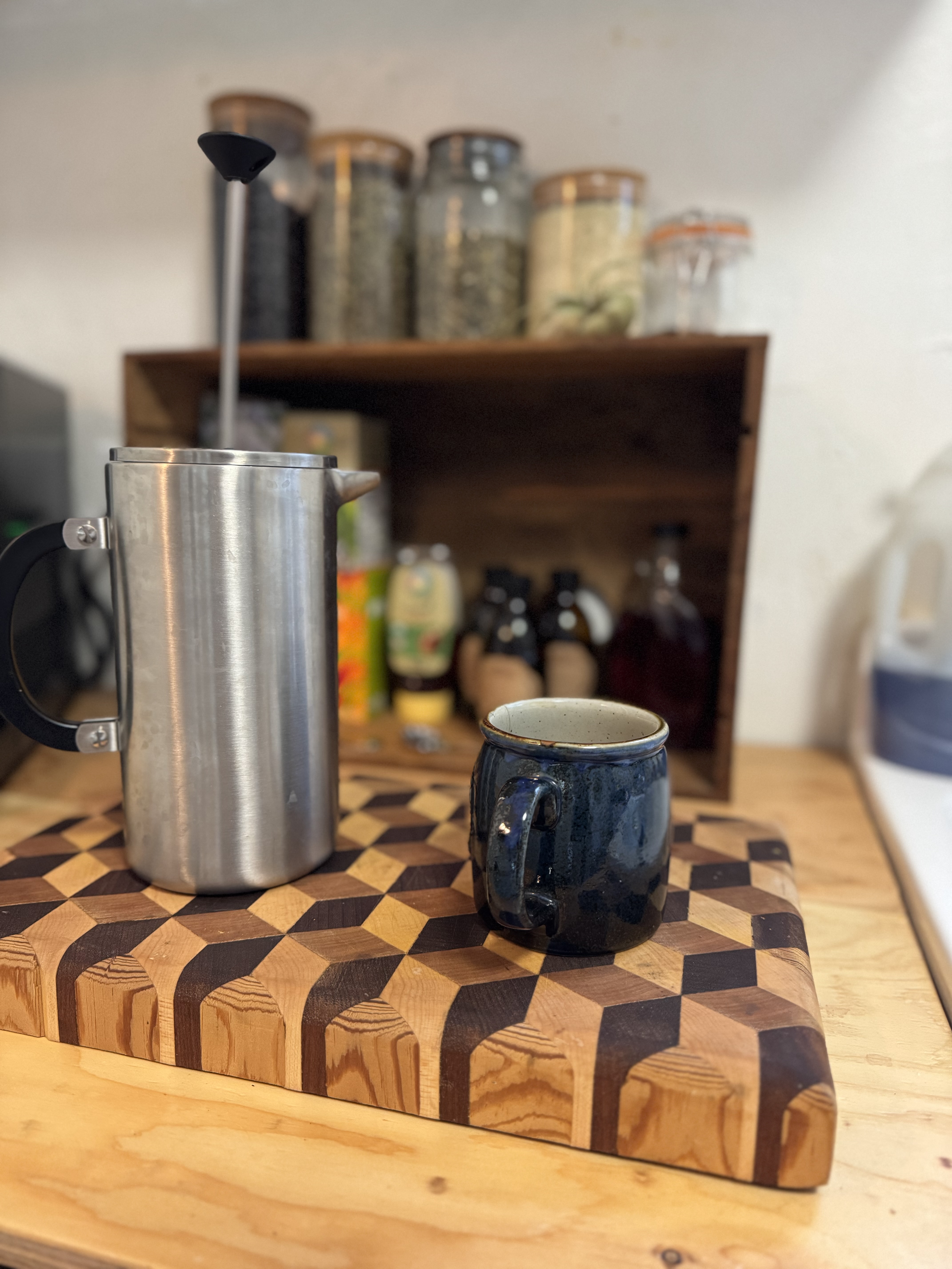 French press and mug on wooden board